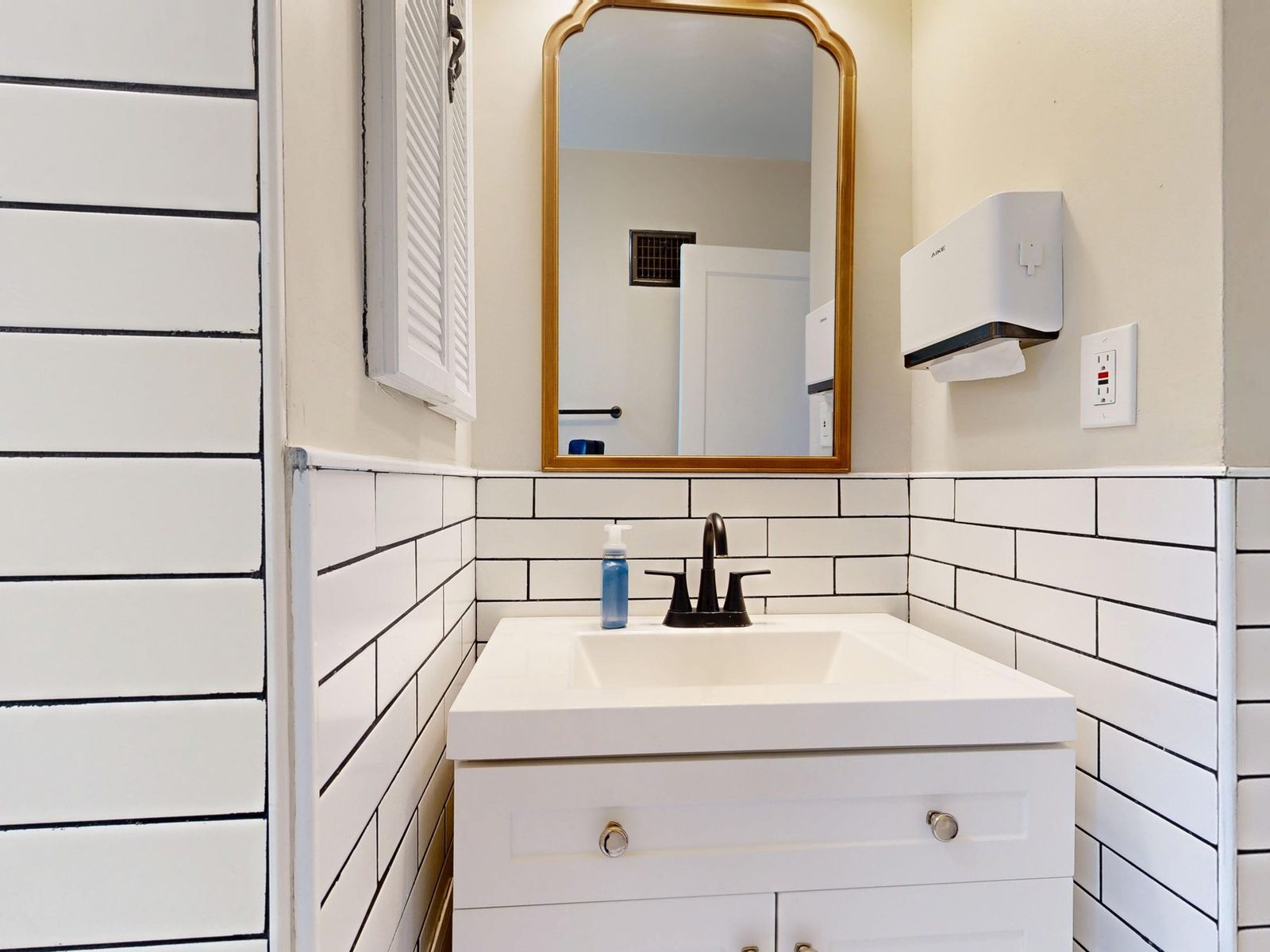 Bathroom vanity with mirror and black-and-white tile