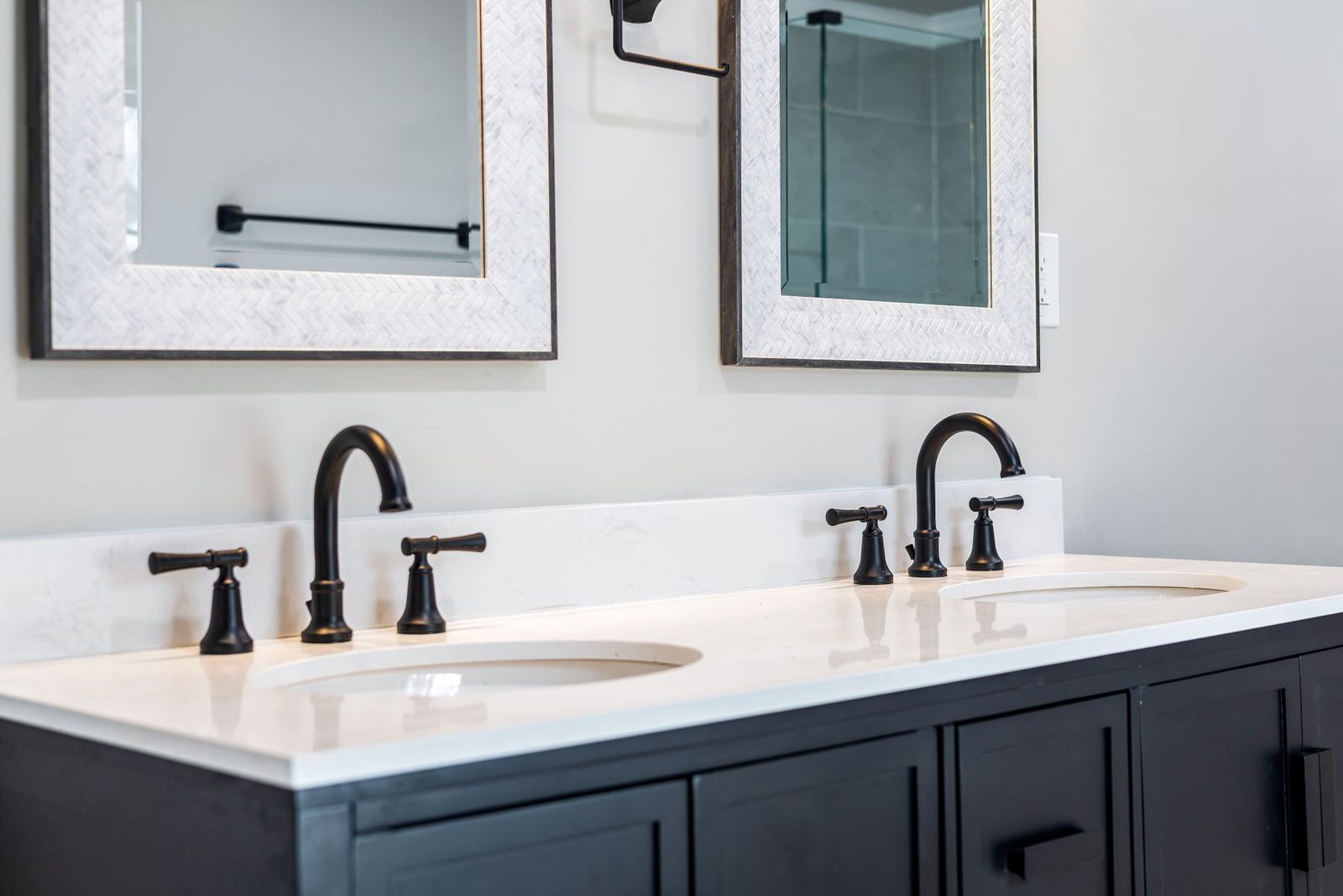Bathroom with double vanity and black faucets