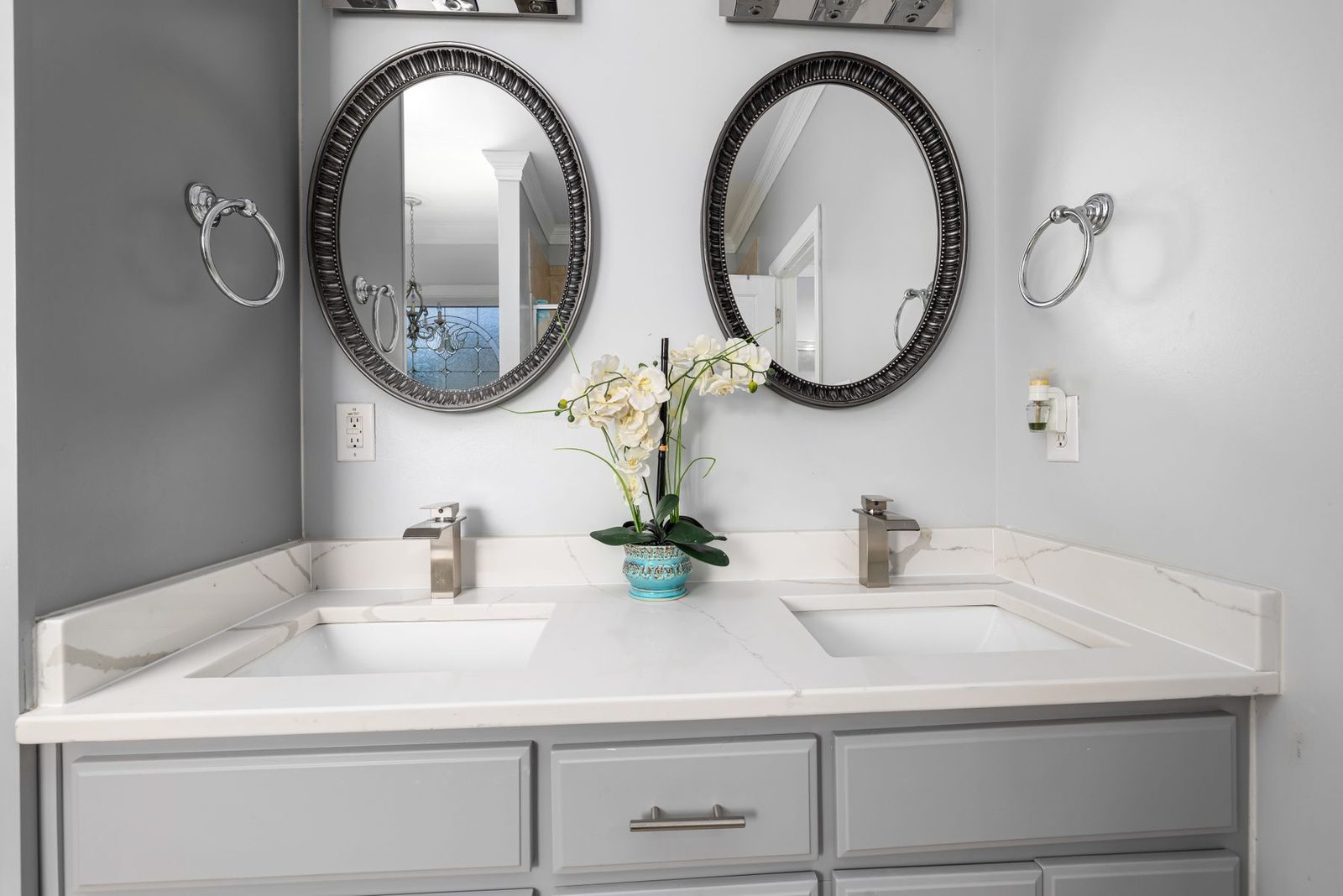 Bathroom with dual sinks and round mirrors
