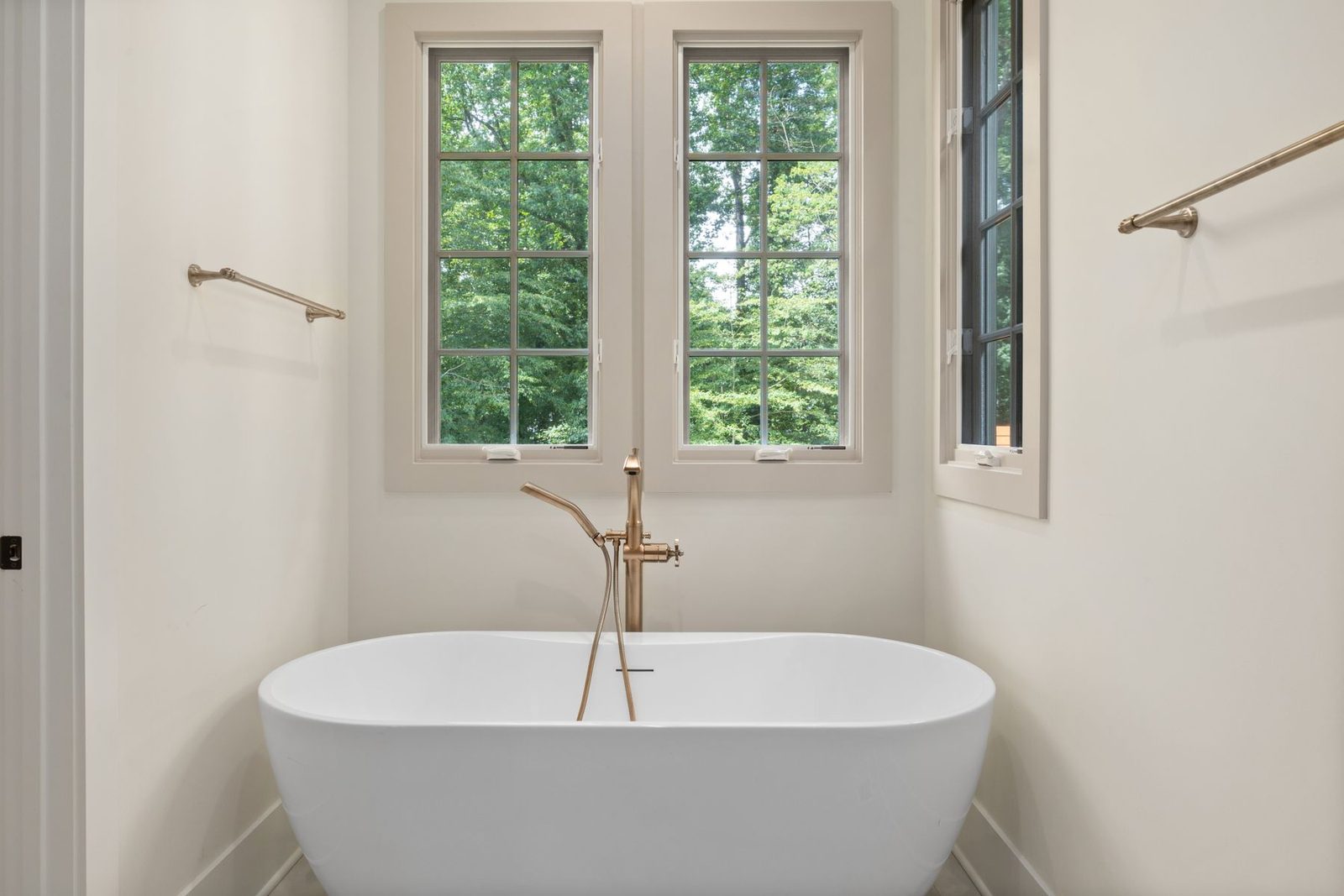 Bathroom with freestanding tub and double windows