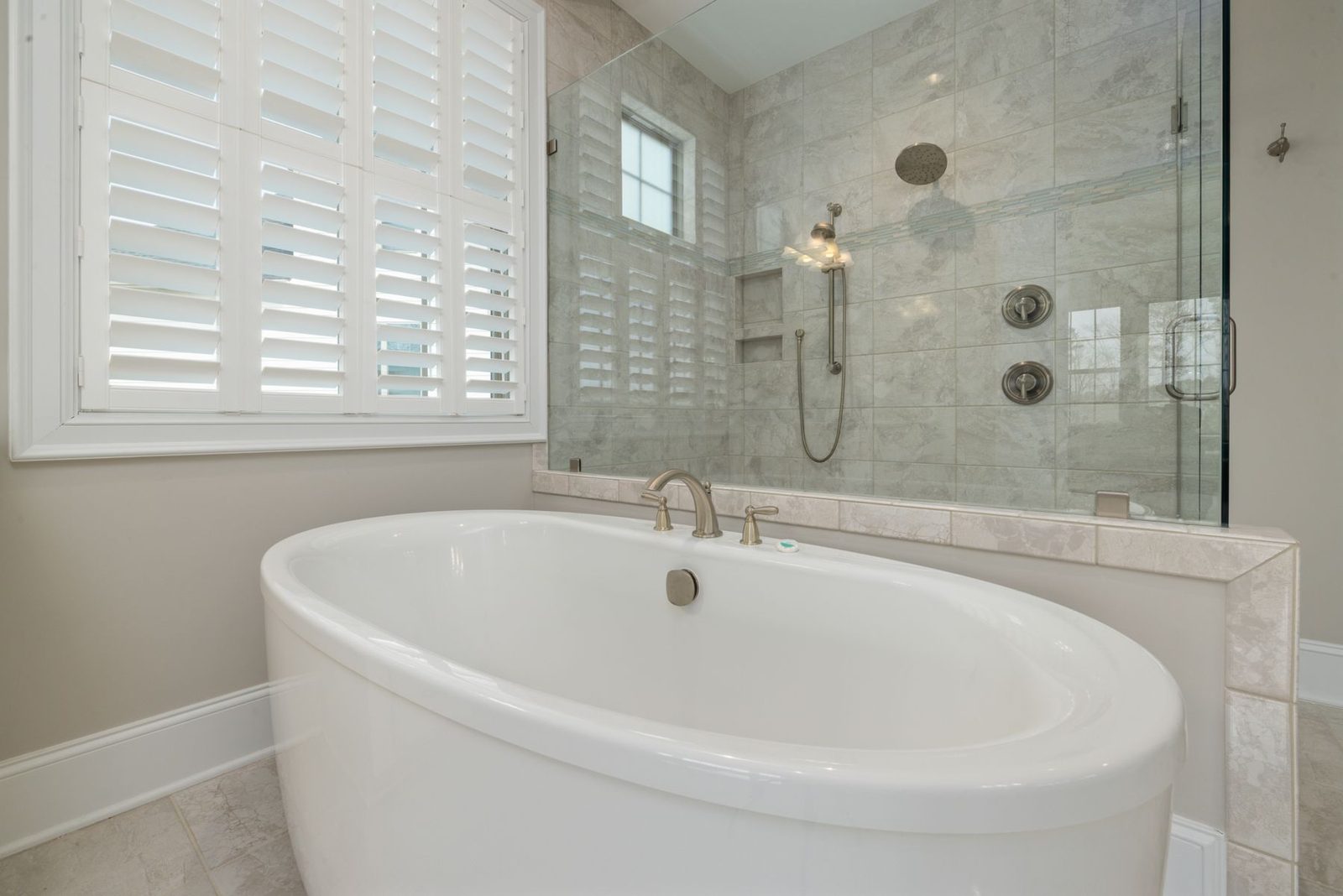 Bathroom with freestanding tub and glass shower