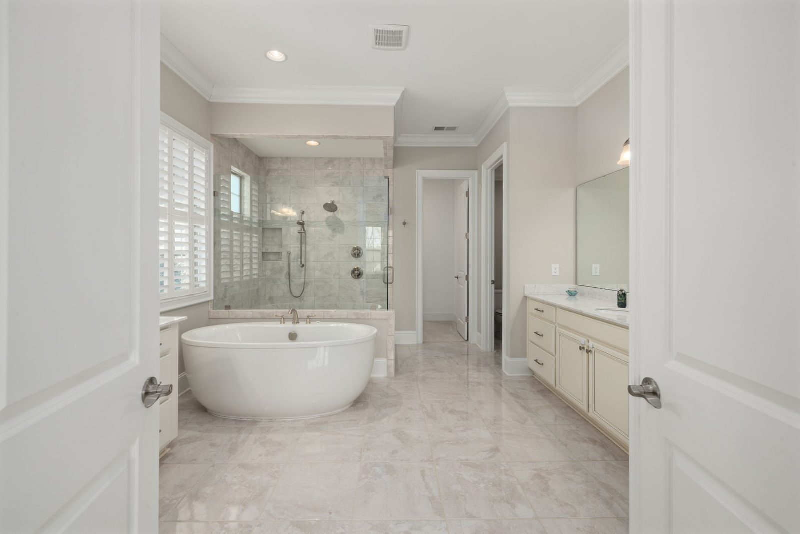 Bathroom with freestanding tub, glass shower and double vanities
