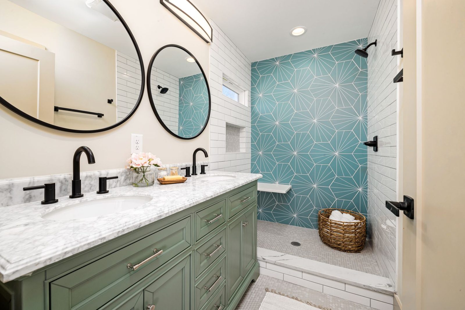 Bathroom with round mirrors and teal accent tile – condo bathrooms