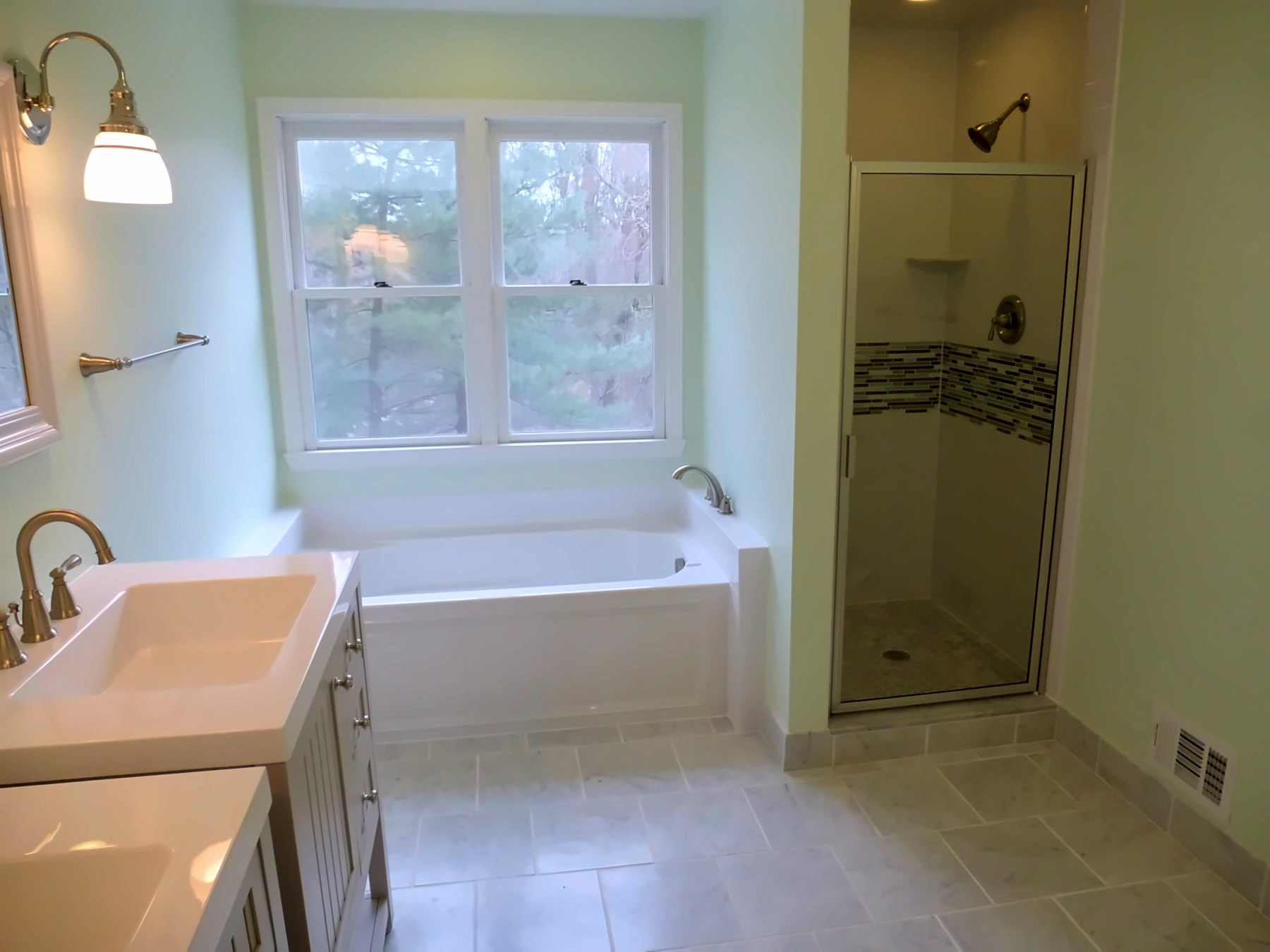 Bathroom with soaking tub and glass-door shower