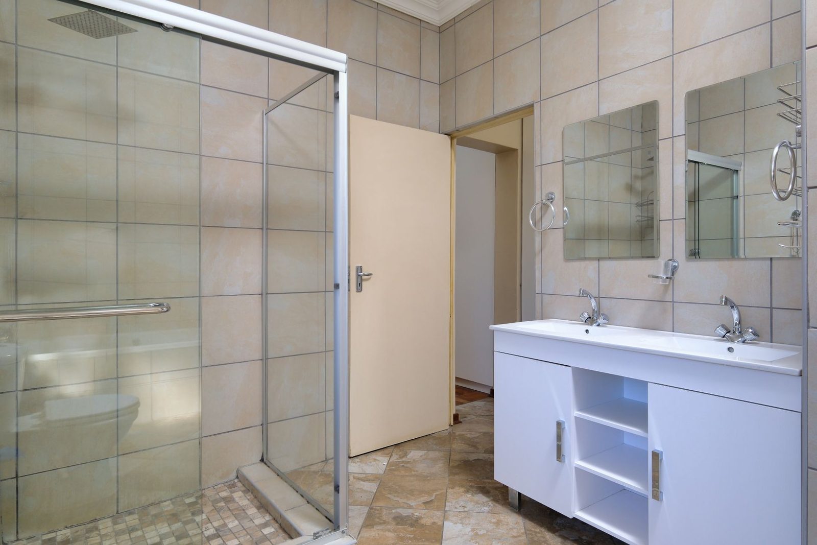 Bathroom with white vanity and glass shower – shore waterproofing