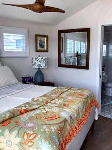 Bedroom with vaulted ceiling, ceiling fan and ensuite bath