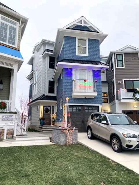 Blue shingle shore home with white trim and front porch