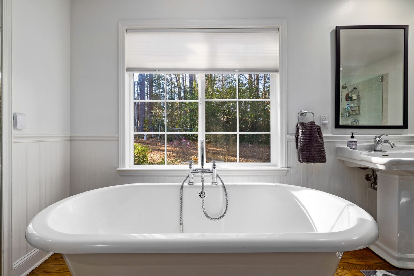 Bright bathroom with freestanding tub and large window