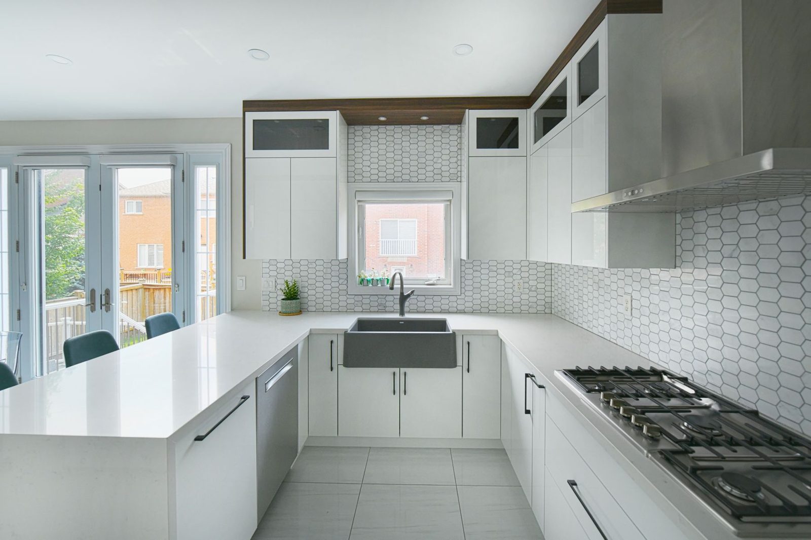 Bright white kitchen with a large island and farmhouse sink – kitchen remodel cost
