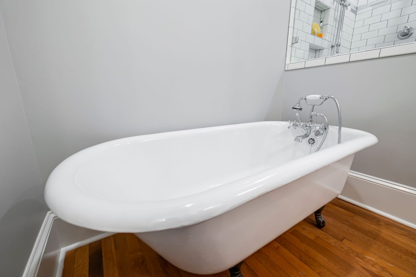 Clawfoot bathtub on a wood floor – gallery
