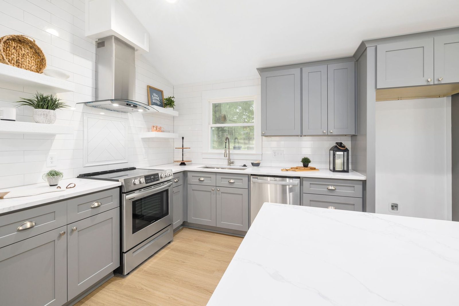 Contemporary kitchen with grey cabinets and stainless steel appliances