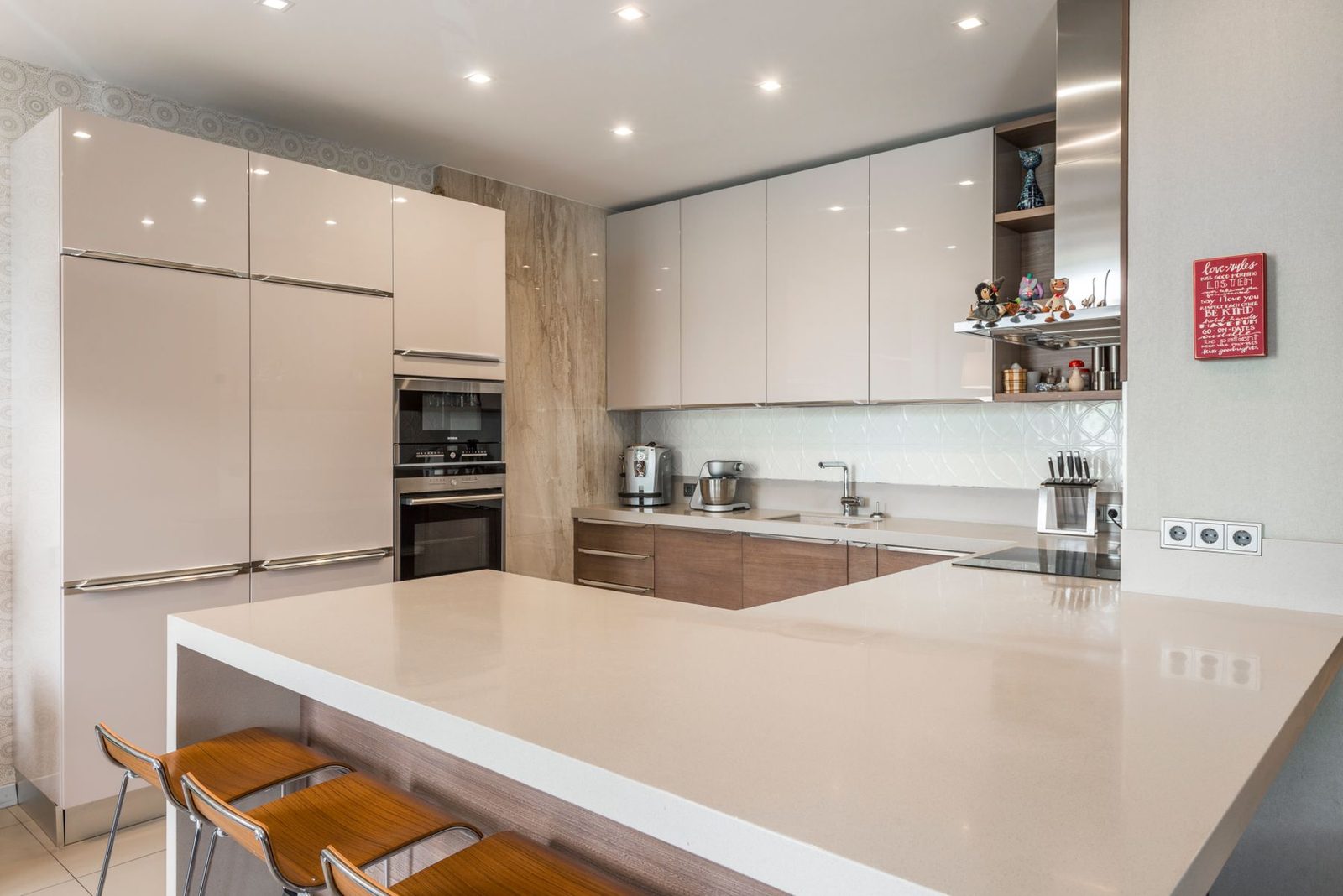 Contemporary kitchen with white and wood cabinets and a round table – kitchen remodeling Ocean City
