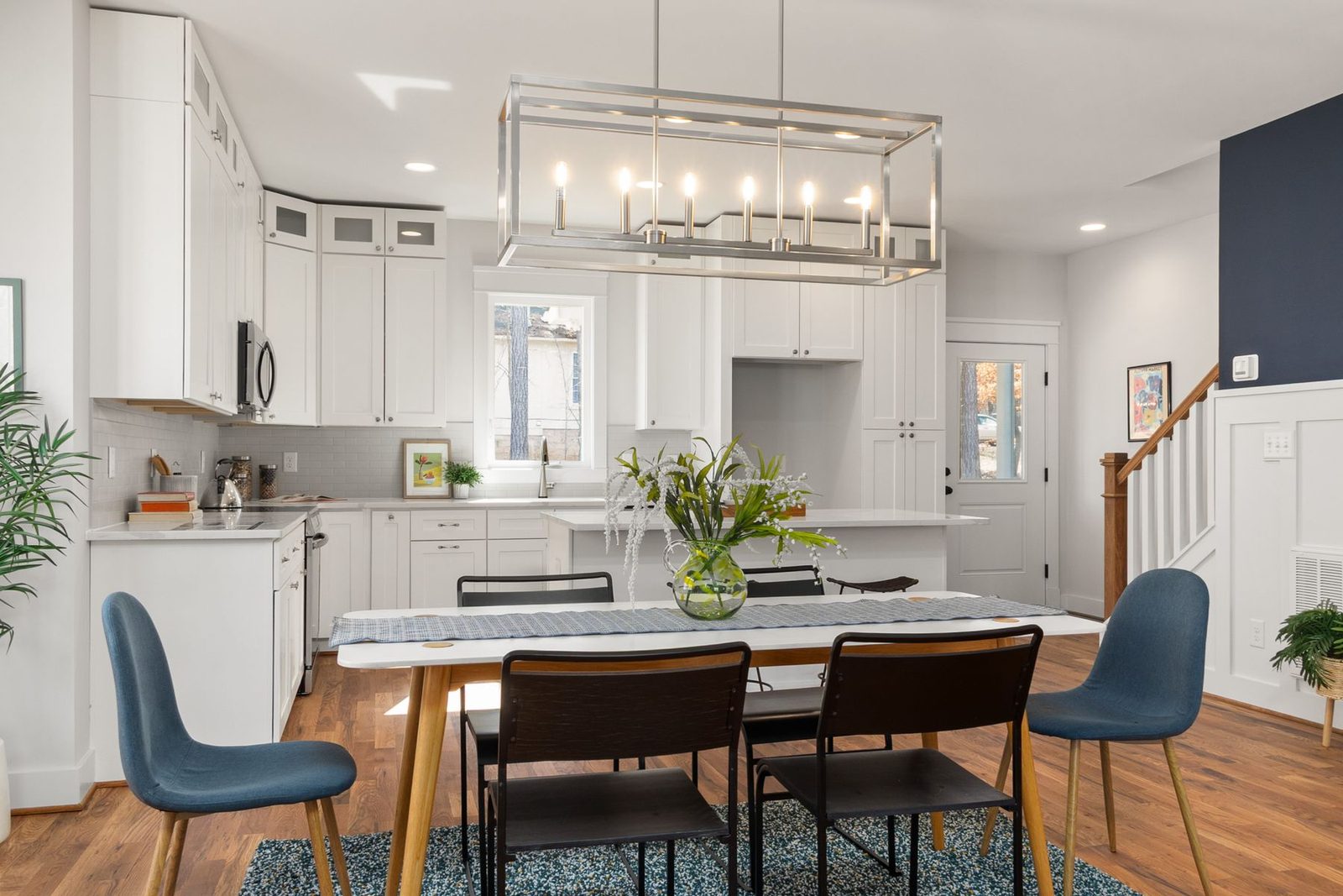 Kitchen and dining area with white cabinets and chandelier – Upper Township NJ remodeling