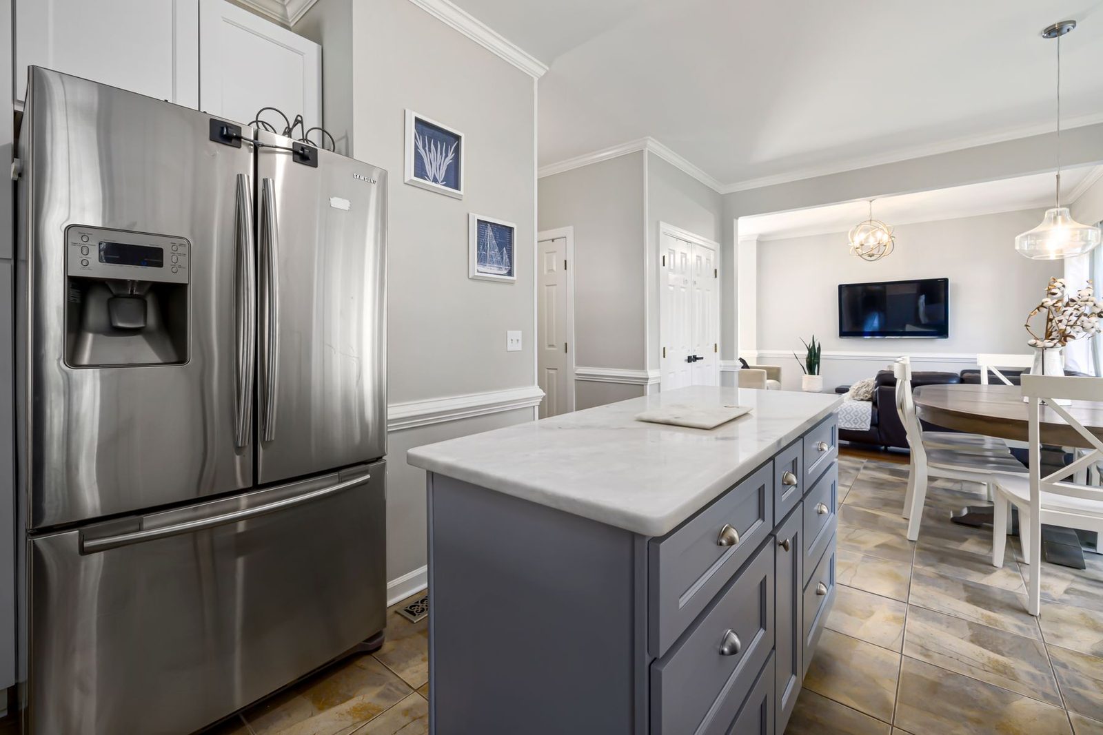 Kitchen island with marble top and stainless steel appliances – condo kitchens