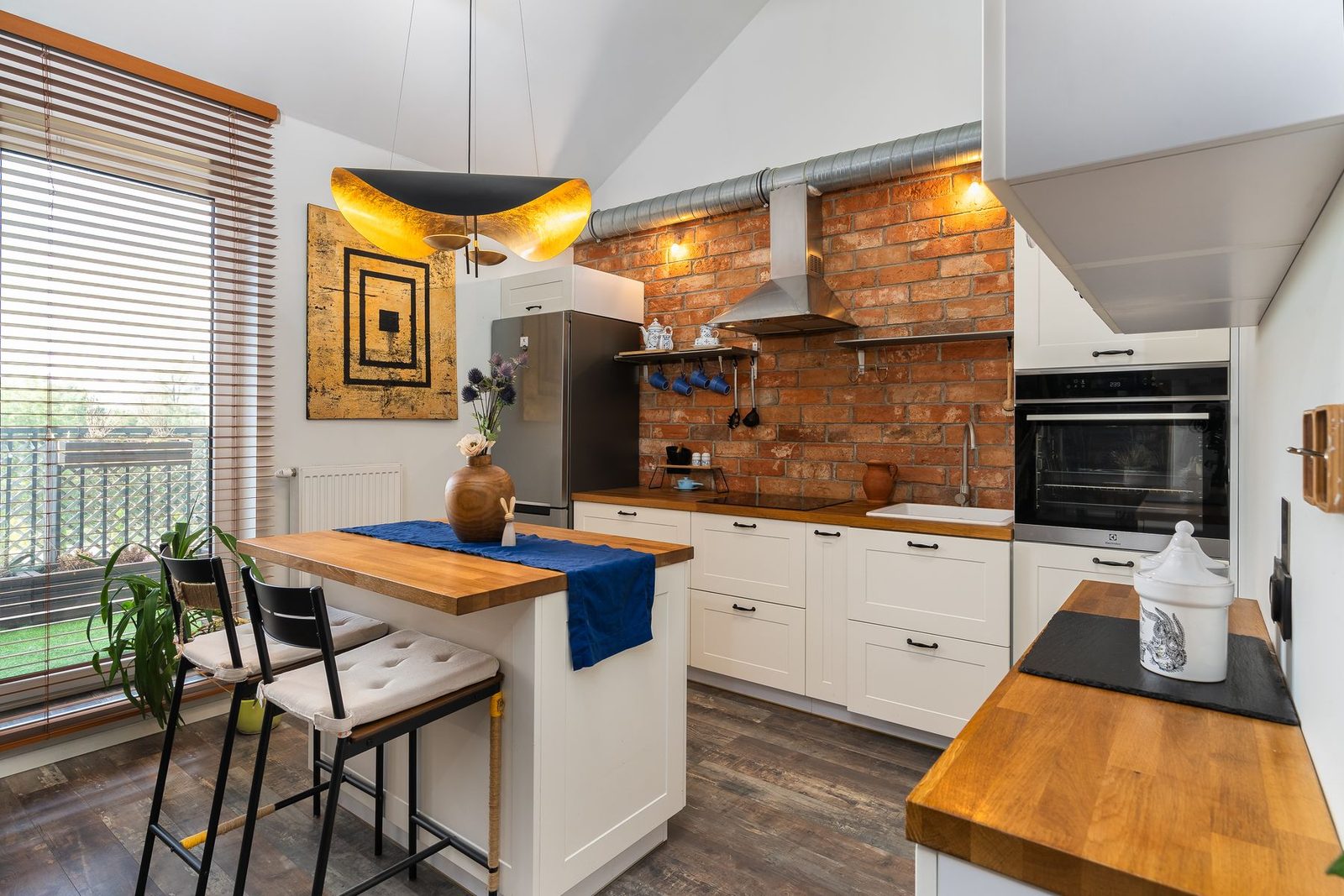 Kitchen with brick accent wall, butcher block counter and pendant lighting – Sea Isle City remodeling