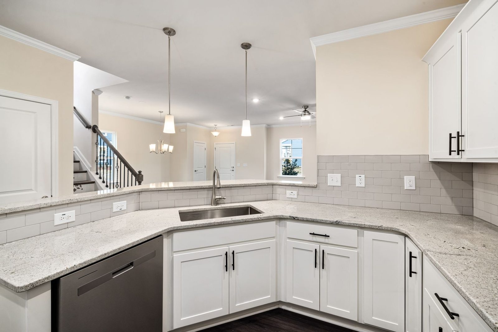 Kitchen with white cabinets, granite counters and pendant lighting – privacy policy