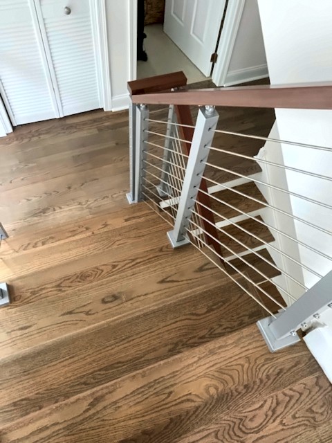 Oak staircase with stainless cable railing and wood handrail