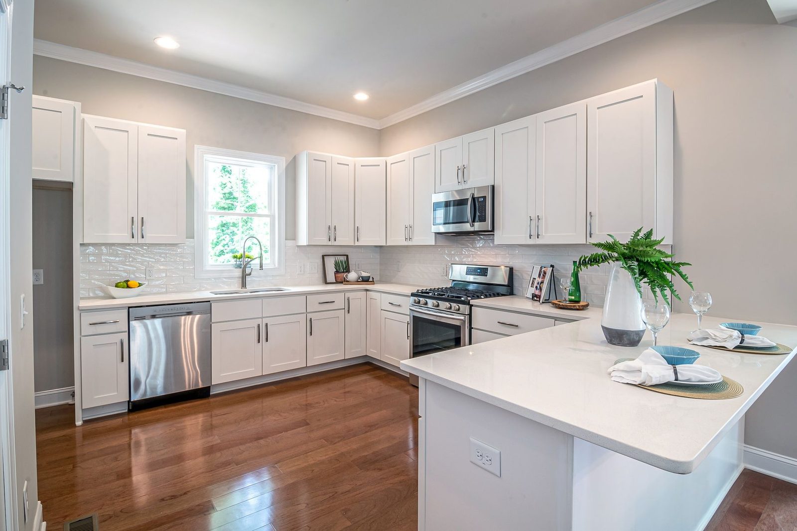 Spacious kitchen with white cabinets and appliances – Ocean City home remodeling