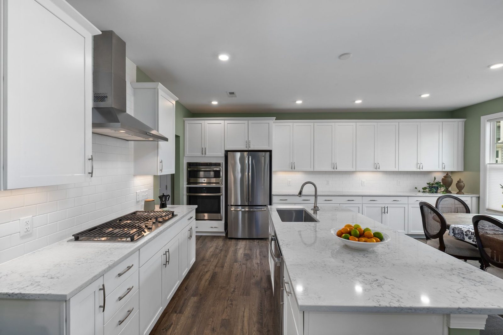 Spacious white kitchen with marble countertops – shore rental remodeling