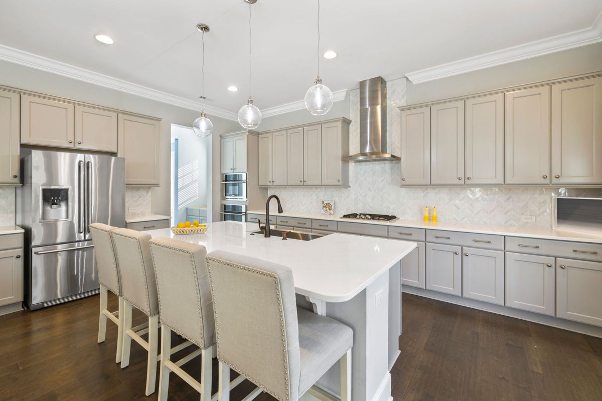 White kitchen with island and pendant lights