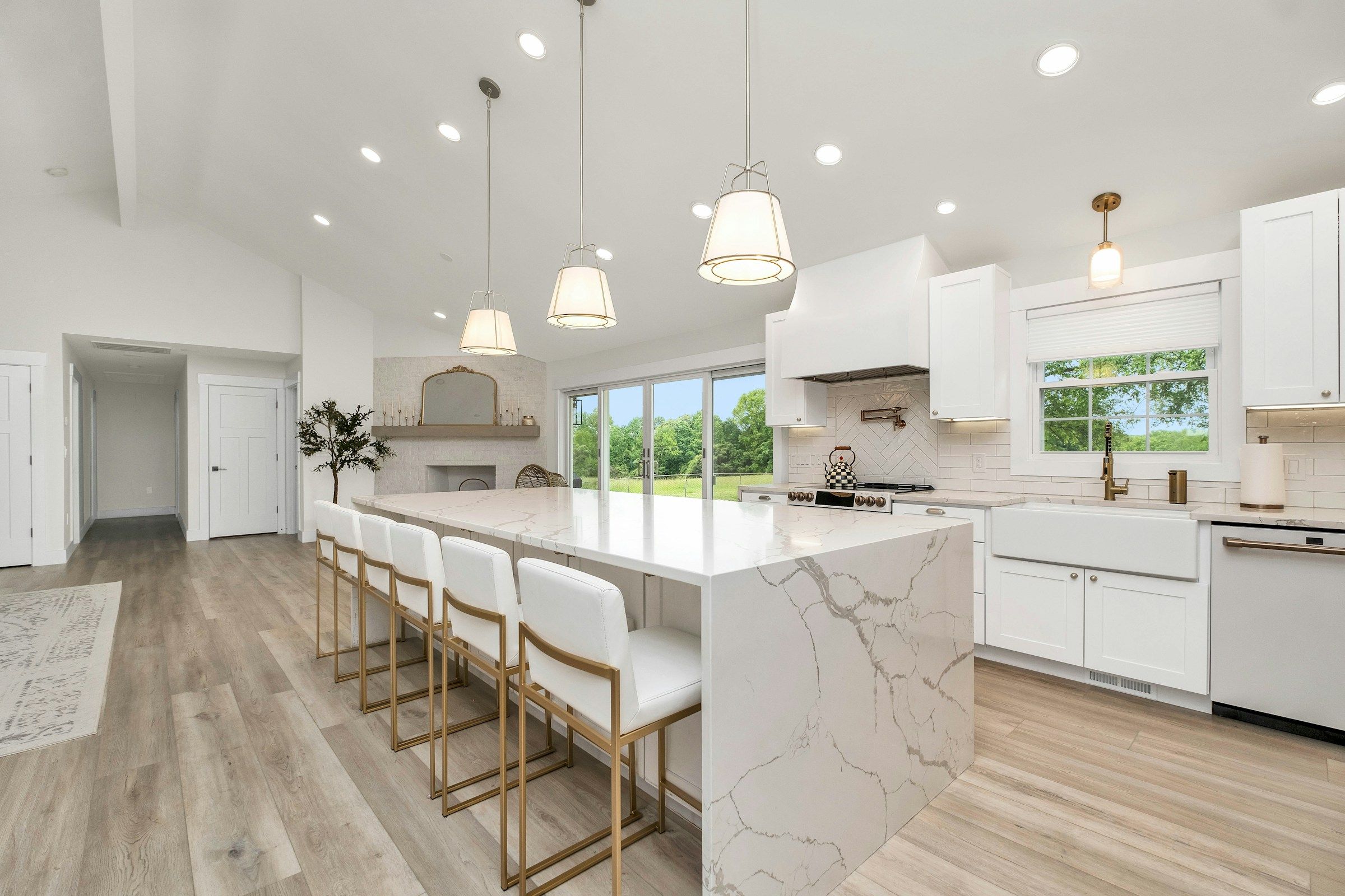 Bright white kitchen with marble island and pendant lights – testimonials
