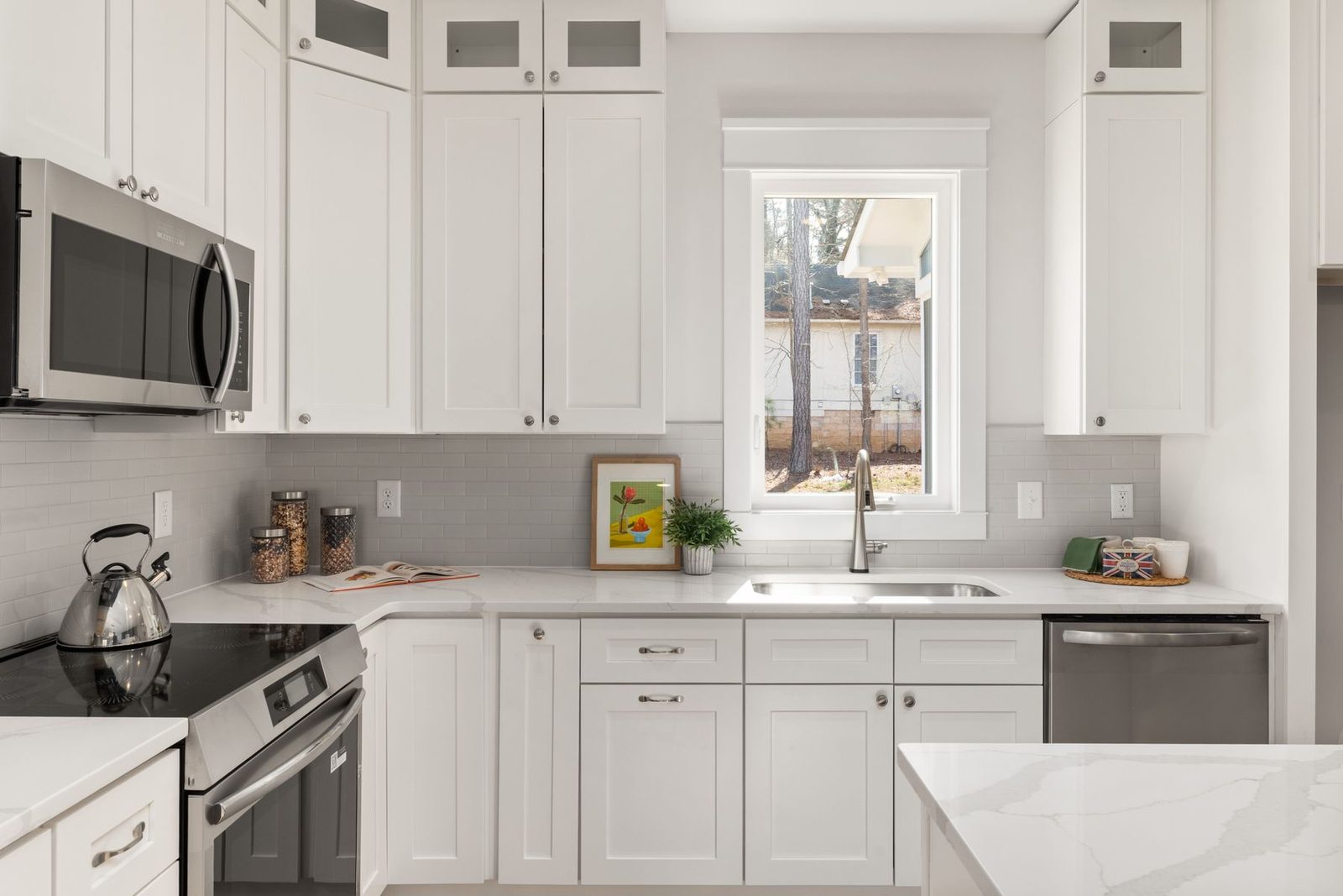 White kitchen with stainless steel appliances and natural light – Linwood NJ remodeling