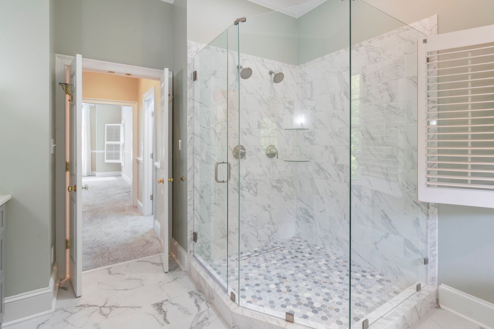 White marble tiled shower with glass doors – bathroom remodeling Ocean City